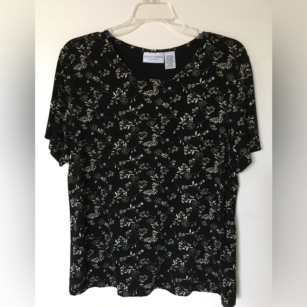 Black stretchy short sleeve top with off white flower pattern.